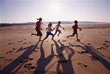 Photo of children running across a beach